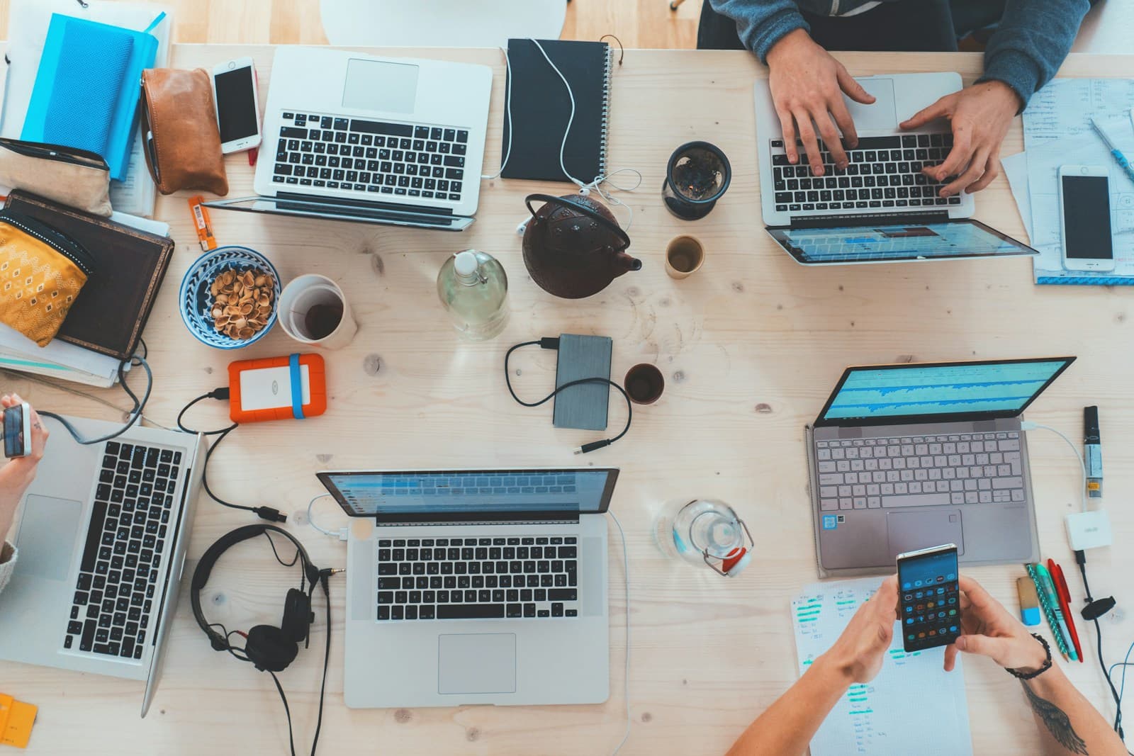 Product team collaborating around desks with laptops